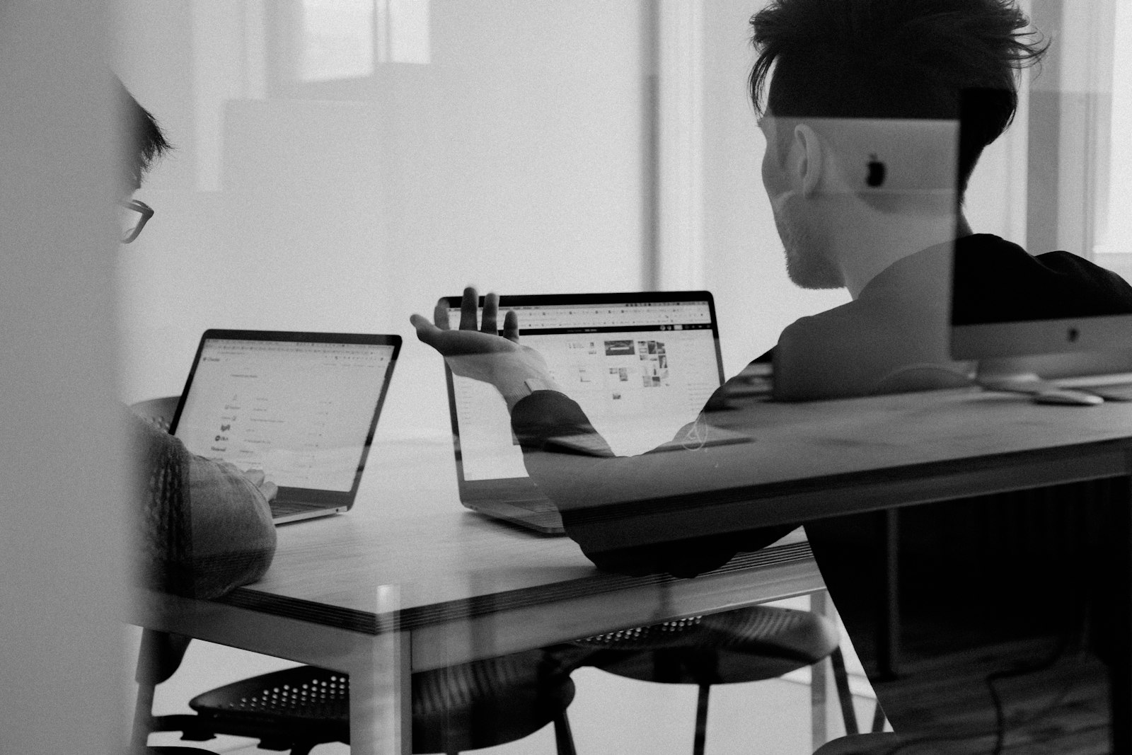 Finance colleagues reviewing printed charts together at a desk